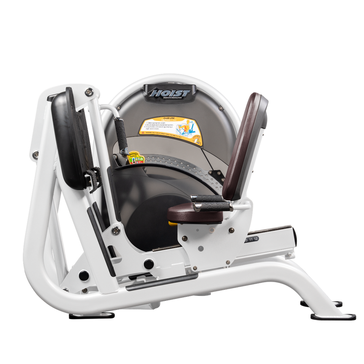 White Seated leg press machine with angled foot platform and back support for lower body strength training