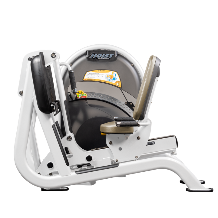 White Seated leg press machine with angled foot platform and back support for lower body strength training