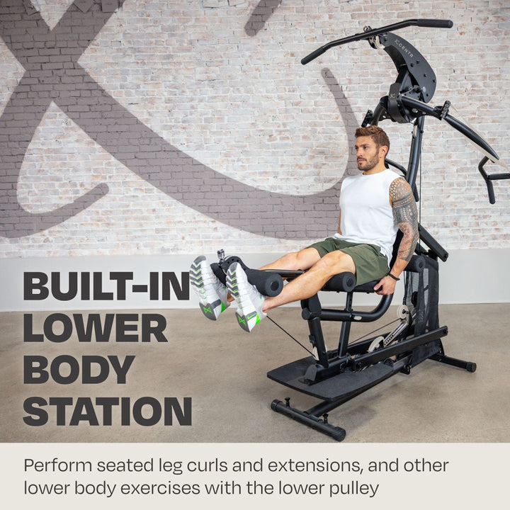 Centr body weight home gym in use at the built-in seated leg curl and extension station