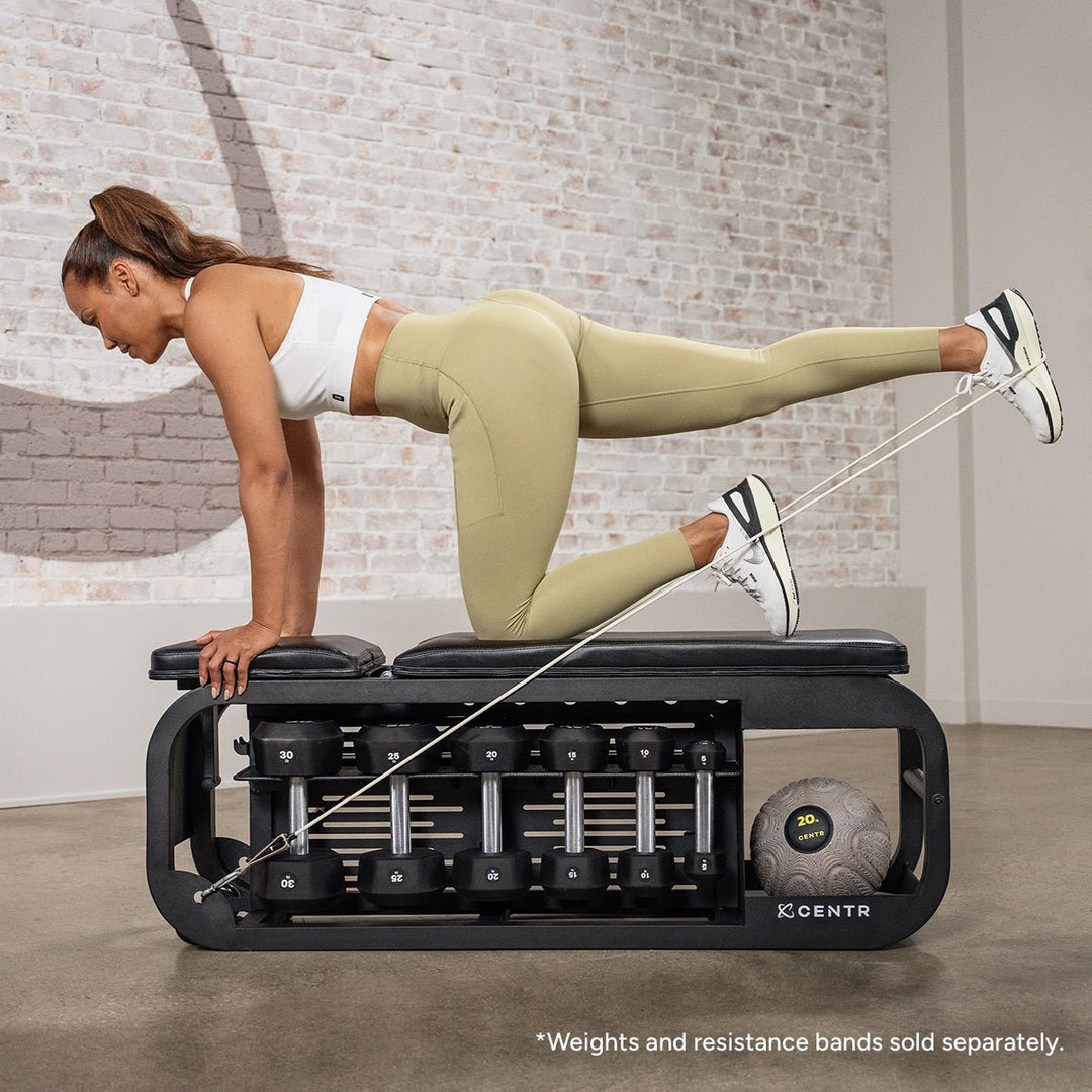 Centr Fusion workout bench used for a supported lower-body exercise in a home gym setting