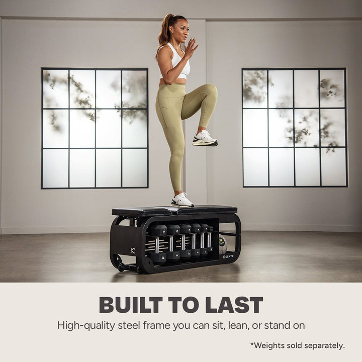 Centr Fusion workout bench used as a platform for a step-up exercise with dumbbells stored below