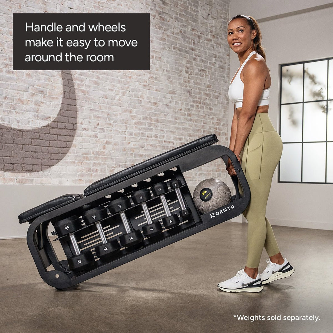 Centr Fusion workout bench being moved using its handle and wheels with dumbbells stored underneath