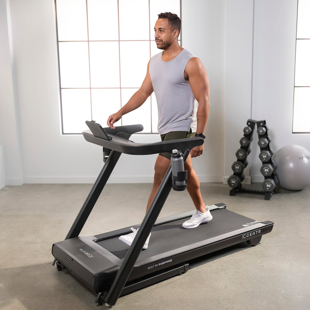Centr Runr folding treadmill in use for a walking workout in a home fitness space