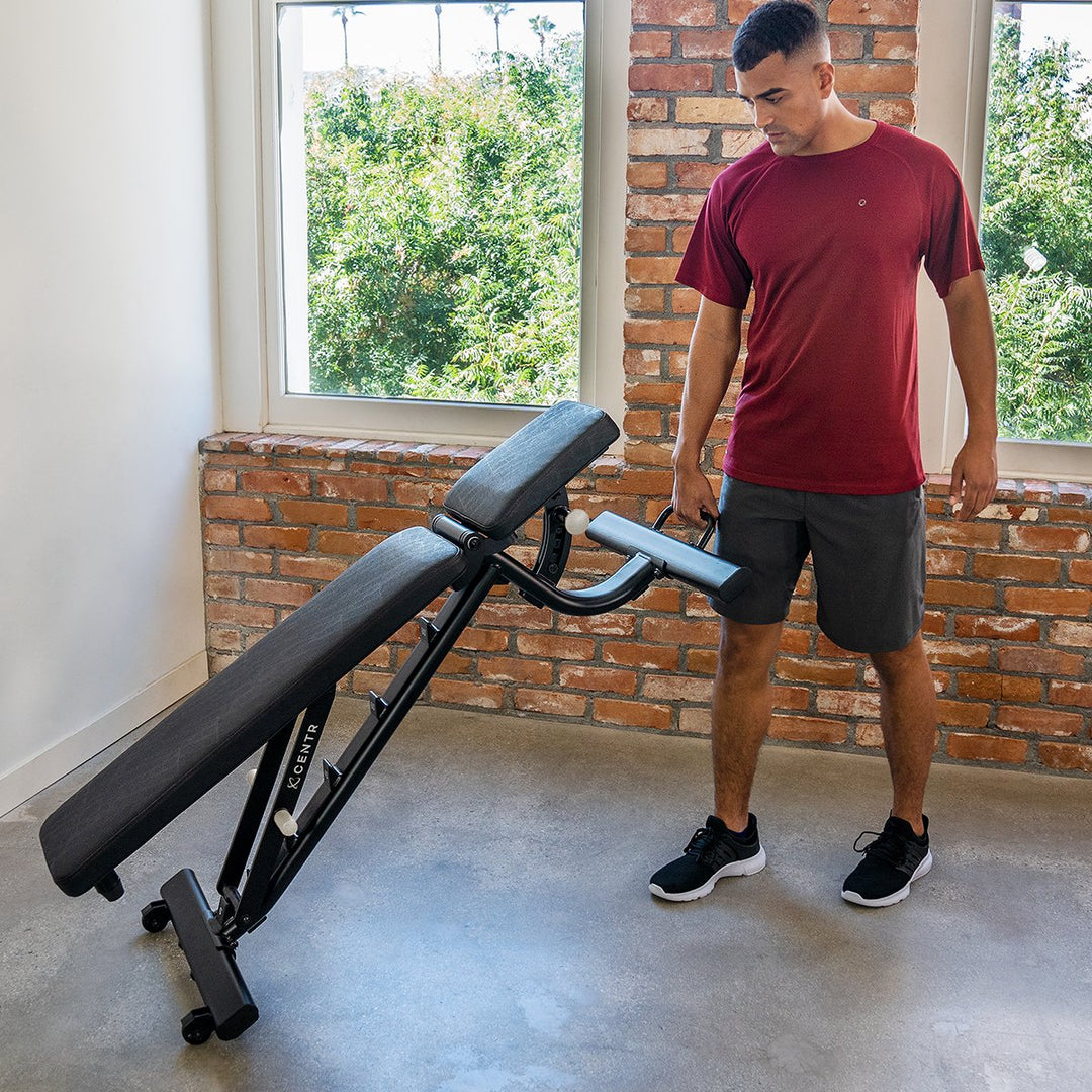 Centr adjustable workout bench being repositioned using its built-in transport handle