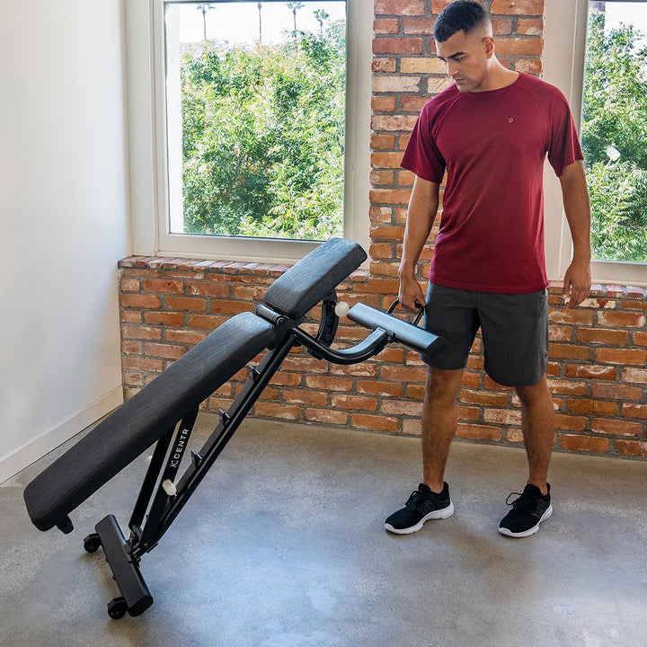 Centr adjustable workout bench being repositioned using its built-in transport handle