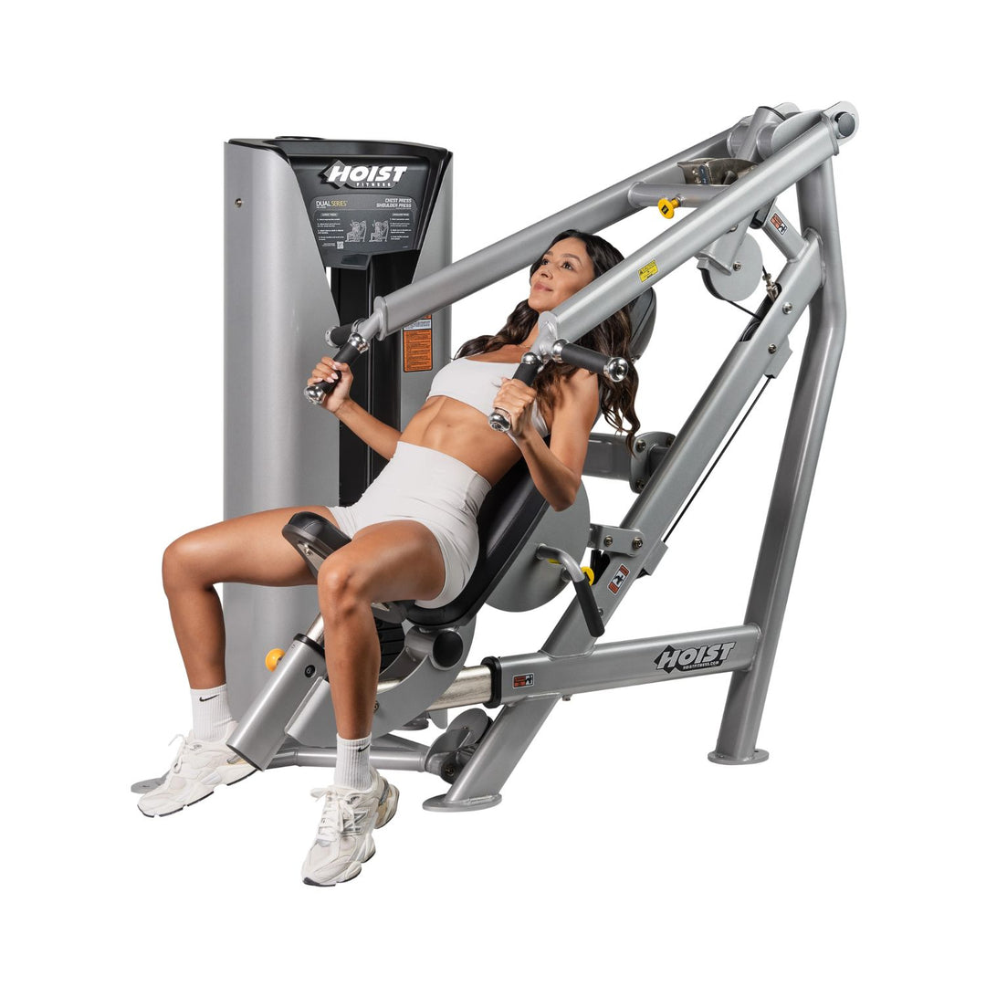 person using chest and shoulder press machine demonstrating upper body workout exercise