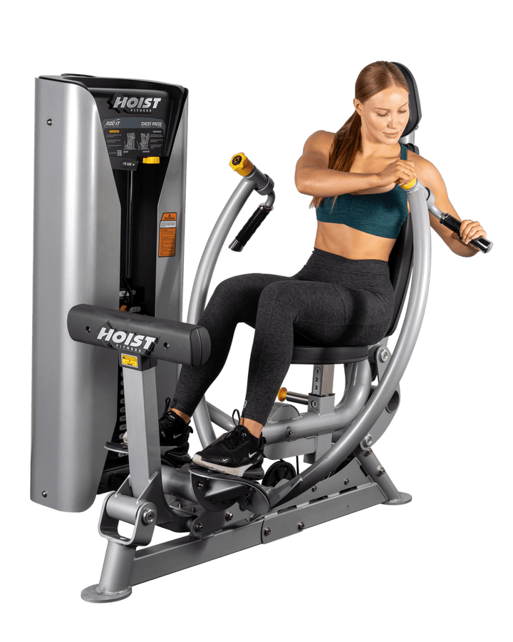 woman performing chest press exercise showing correct pushing motion and upper body positioning