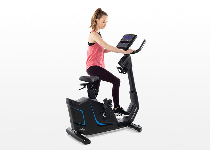 User riding the Horizon 5.0U upright exercise bike with an upright posture.