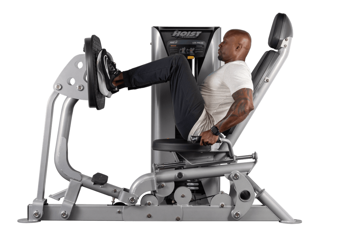 athlete performing seated leg press exercise on Hoist commercial lower body strength machine