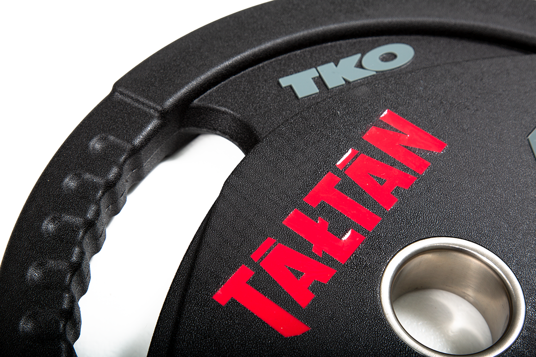 Close-up of laser-engraved logo detail on custom Olympic urethane weight plate