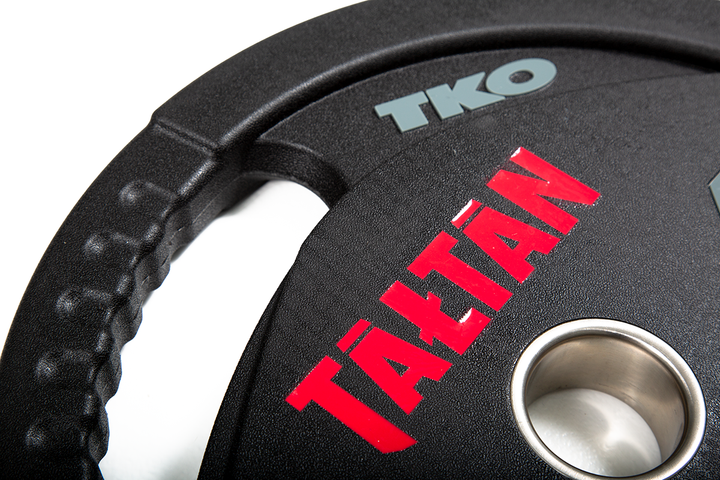 Close-up of laser-engraved logo detail on custom Olympic urethane weight plate