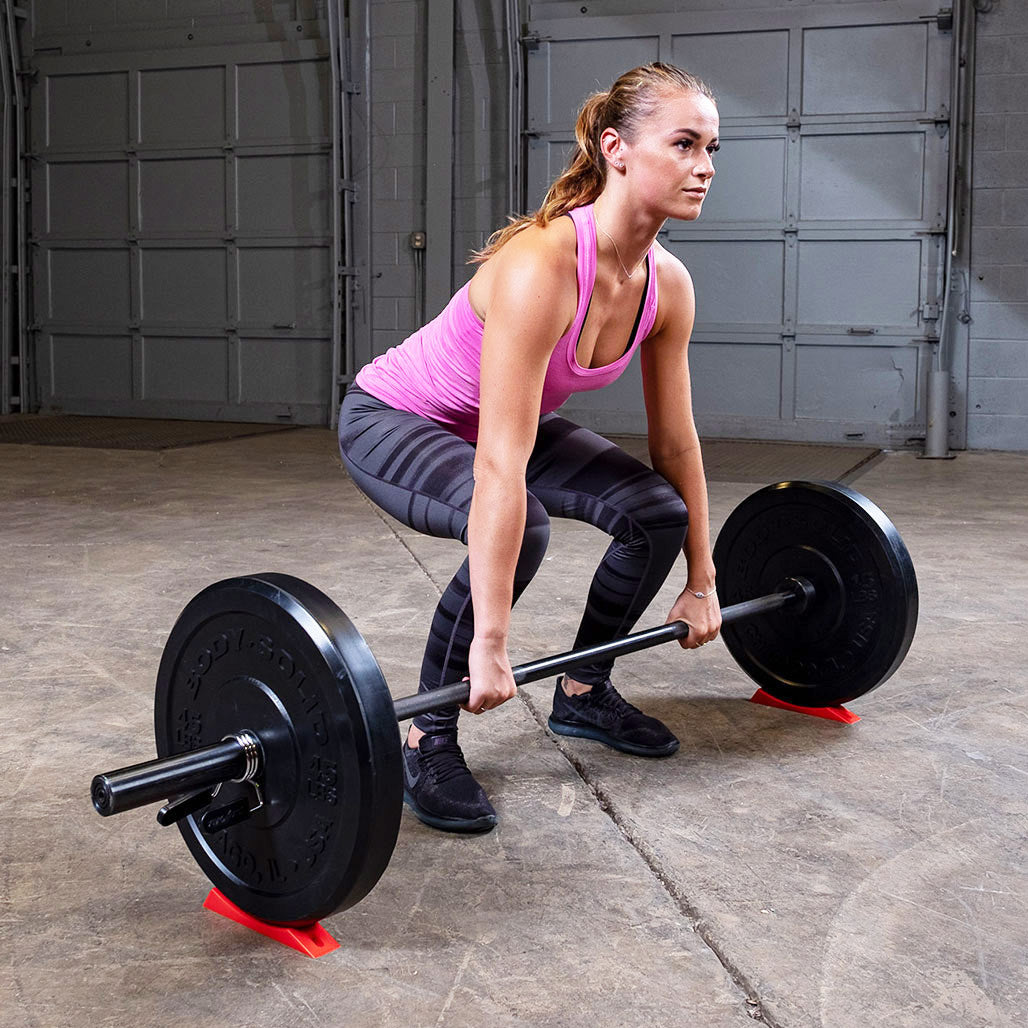 Athlete using the deadlift wedge while preparing for a deadlift.