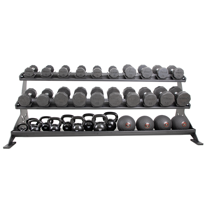 Defiant Strength 3 tier tray rack storing dumbbells, kettlebells, and wall balls.