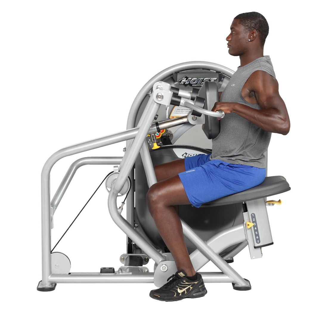 User performing mid row pulling handles toward torso demonstrating contracted position and back engagement