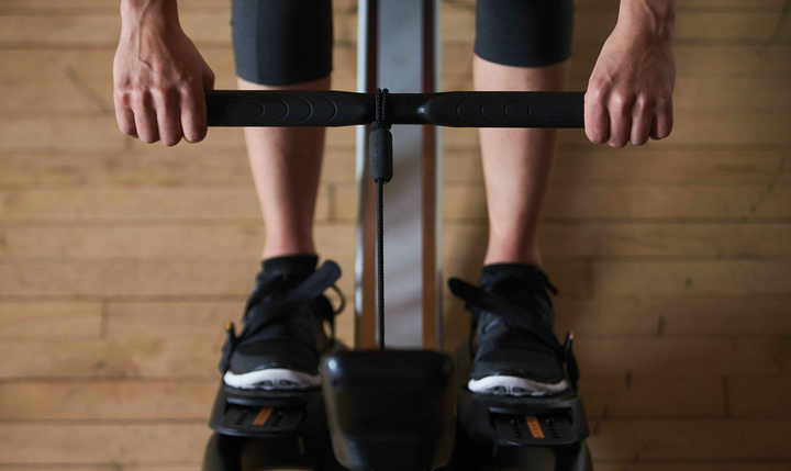 Close-up of the ergonomic rowing handle on the Matrix rowing machine.
