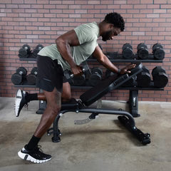 User adjusting TKO FID bench in a gym training space