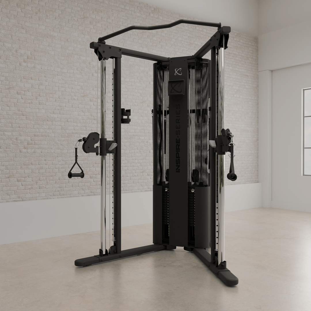 Angled view of Centr Inspire FT1 PRO functional trainer showing its frame, cables, and pulley stations