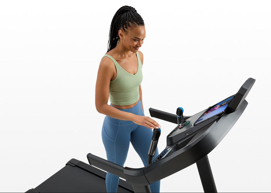 User syncing workout data on the Horizon 7.0 AT treadmill with a fitness app.
