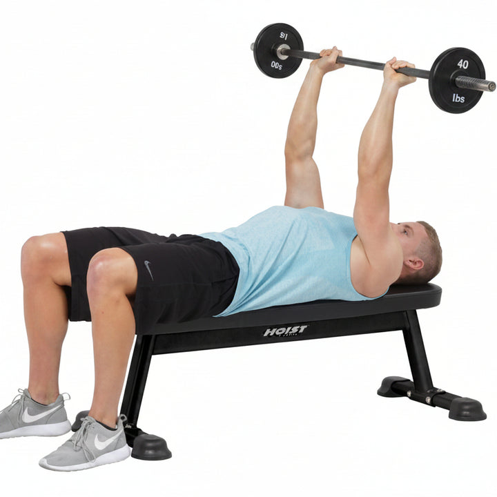 Flat utility bench barbell press exercise for chest and upper body strength training in gym workouts