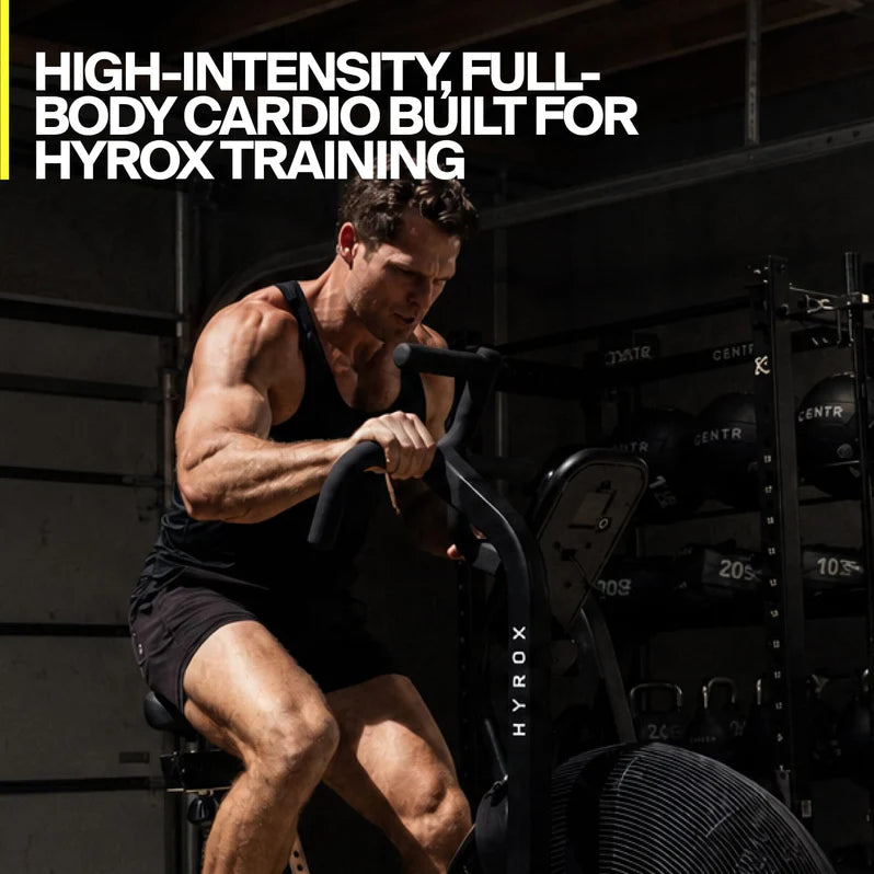Athlete performing a full-body cardio workout on the Centr x HYROX Perform Series air bike.