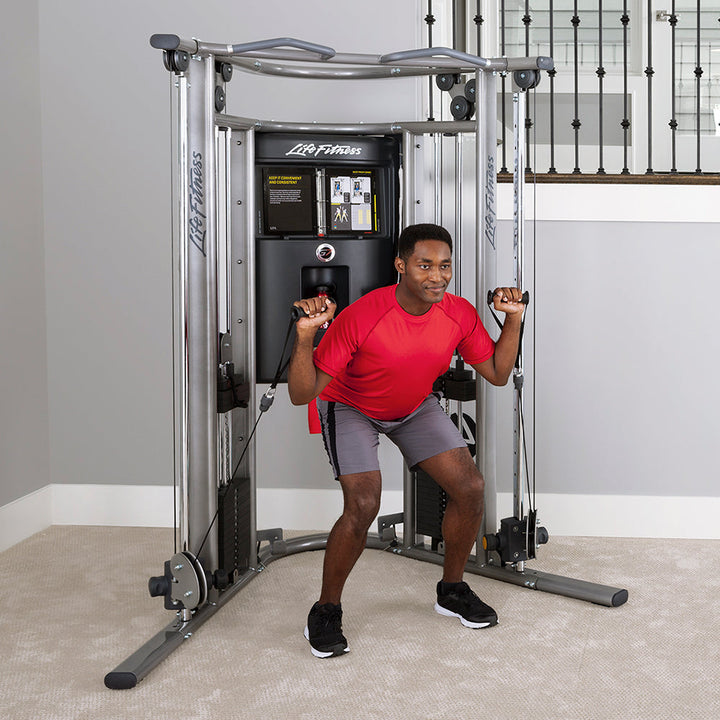 Life Fitness G7 home gym with user performing cable squat exercise using adjustable pulley resistance system