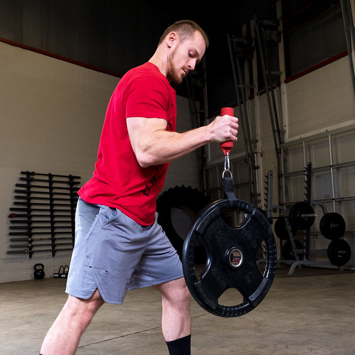 Person using Body-Solid nunchuck grips attached to a weight plate for grip training.