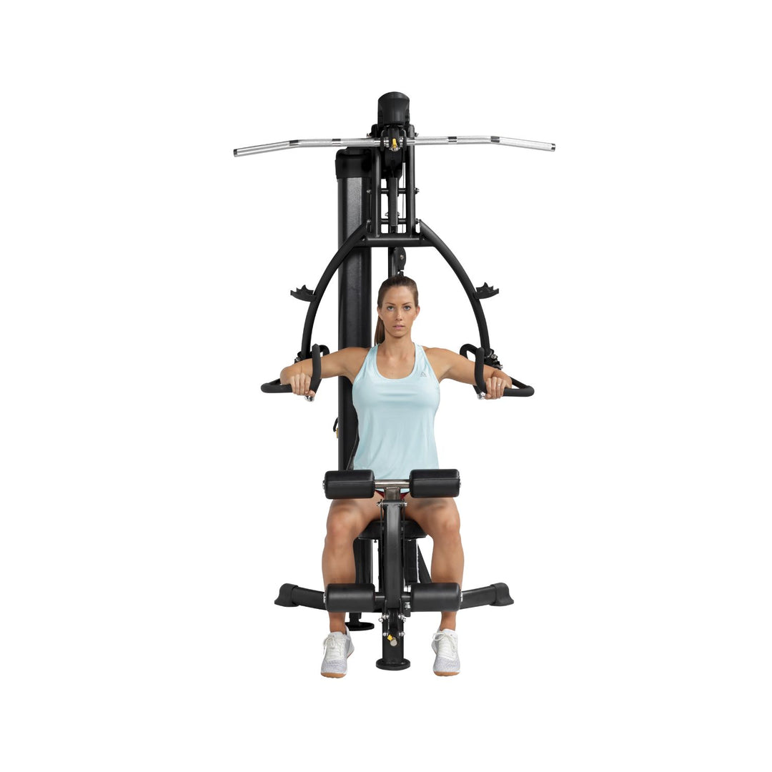 HOIST Mi1 home gym chest press exercise demonstrating proper form for upper body strength training