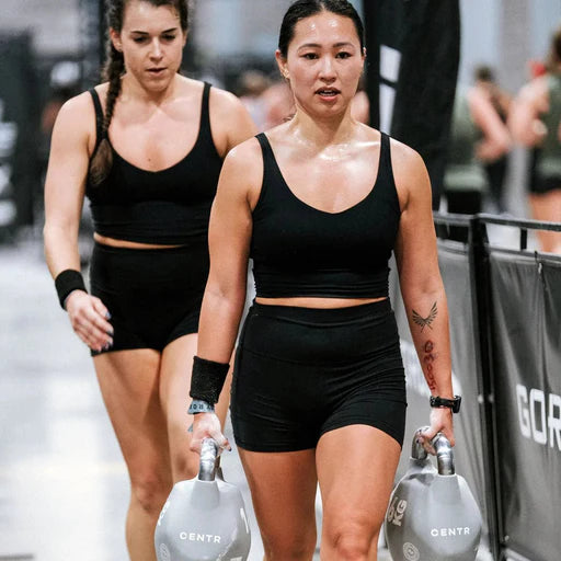 Athletes performing Farmer's Carries with Centr x HYROX Competition Octo Kettlebells.