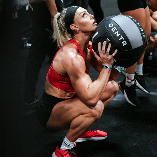 Athlete completing a wall ball squat throw using the Centr x HYROX Official Wall Ball.