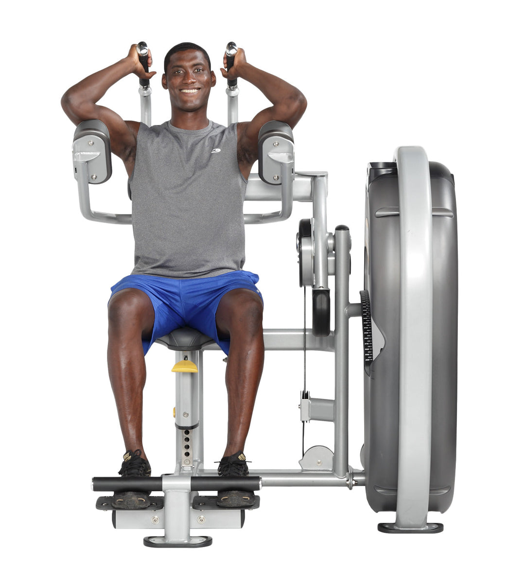 User seated on abdominal machine holding handles with torso upright preparing to perform crunch