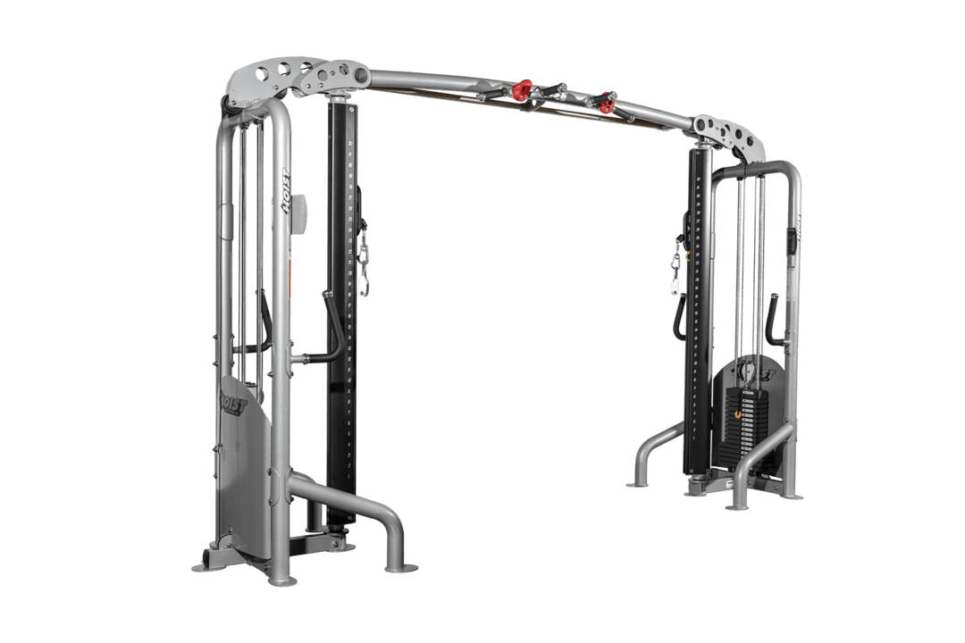 Angled view of cable crossover showing dual towers, connecting pull-up bar, and open workout space