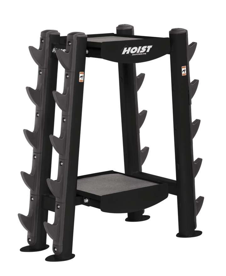 Commercial gym accessory rack with vertical slots for storing bars and attachments and a central storage platform
