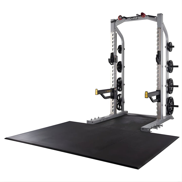 Hoist half rack in silver frame with integrated lifting platform and plate storage for strength training