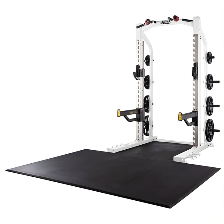 Hoist half rack in white frame with lifting platform and weight plate storage for commercial gym use