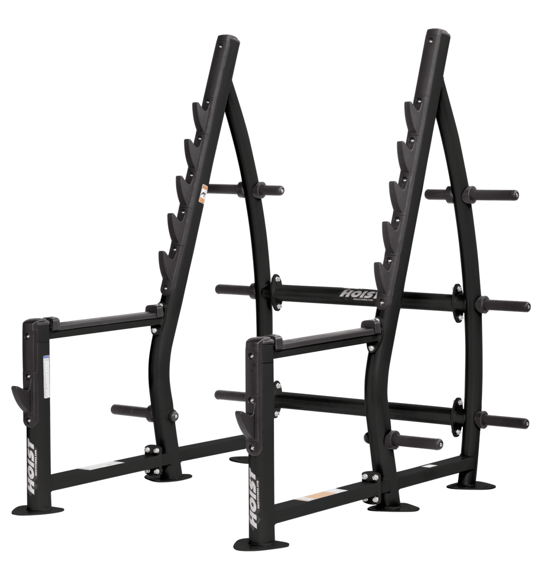 Commercial squat rack with angled uprights, multiple barbell racking positions, and weight plate storage