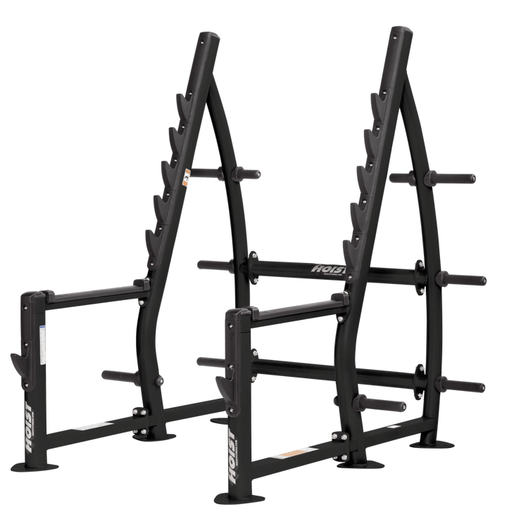 Commercial squat rack with angled uprights, multiple barbell racking positions, and weight plate storage
