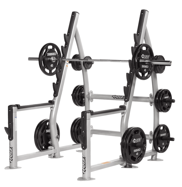 Squat rack setup with loaded barbell and weight plates stored on side pegs