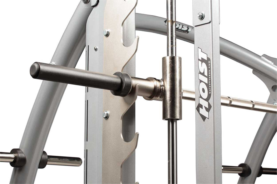 Close-up of Smith machine barbell sleeve and guide rod system showing smooth linear movement