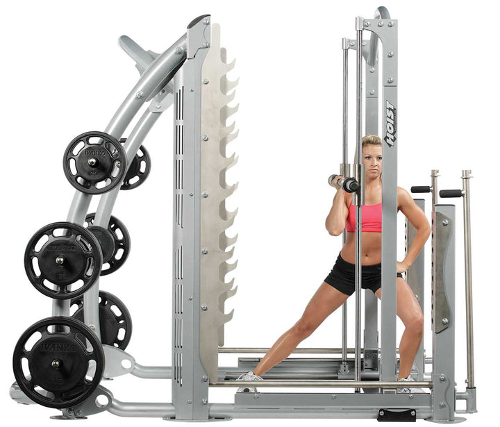 User performing squat on dual action Smith machine demonstrating stable guided bar path and wide stance positioning