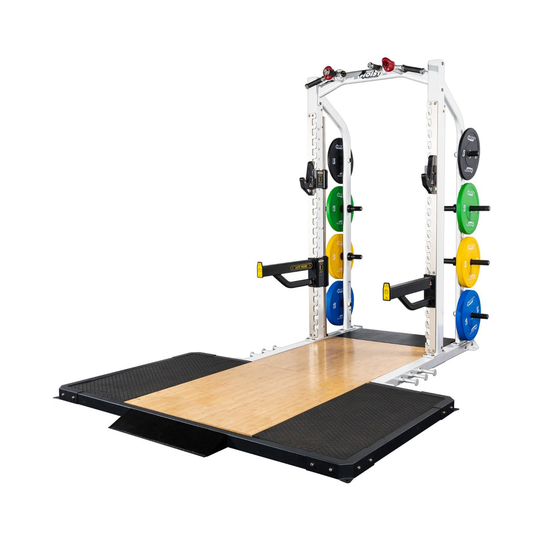 Hoist half rack combined with lifting platform and plate storage for full gym setup