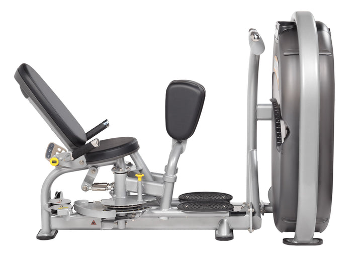 Side view of user seated on thigh machine showing leg positioning and symmetrical movement during exercise