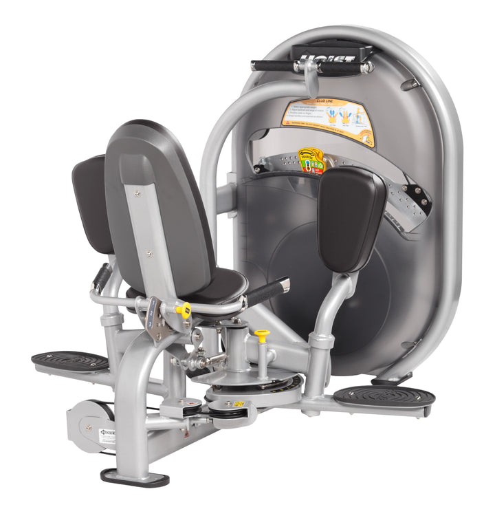 Side profile of thigh machine highlighting seat, backrest, and circular resistance housing