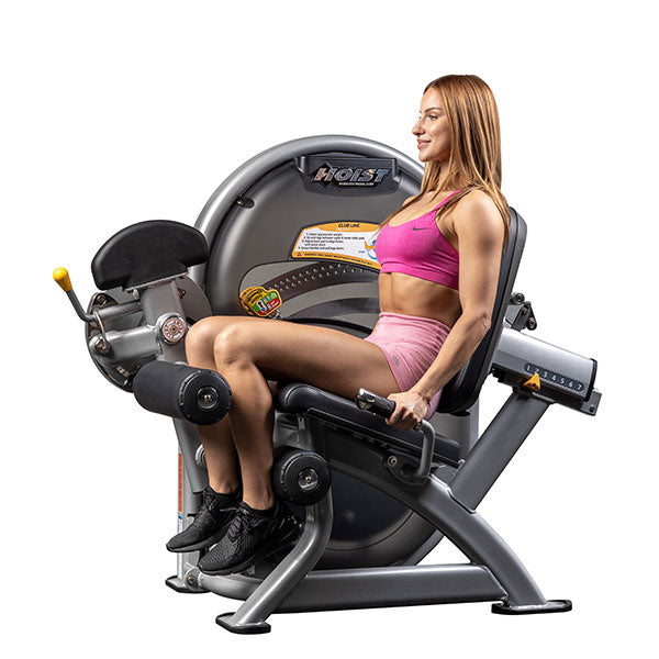 User performing leg curl with knees bent demonstrating hamstring contraction and controlled movement