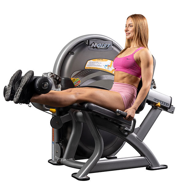 User performing leg extension with legs fully extended demonstrating quadriceps contraction