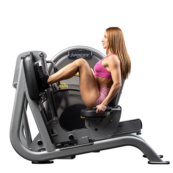 User performing leg press with legs extended demonstrating controlled lower body movement