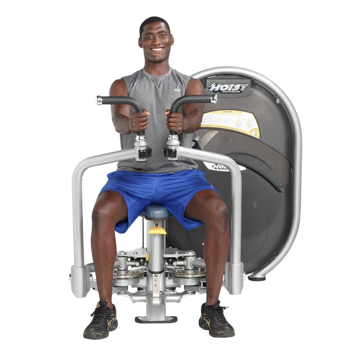 User performing rear delt reverse fly movement targeting shoulders on dual-function machine