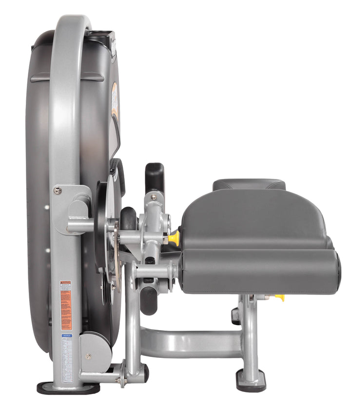 Angled view of leg curl machine showing dual-use configuration and ergonomic support pads