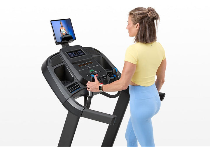 Horizon 7.0 AT treadmill folded upright for compact home storage.