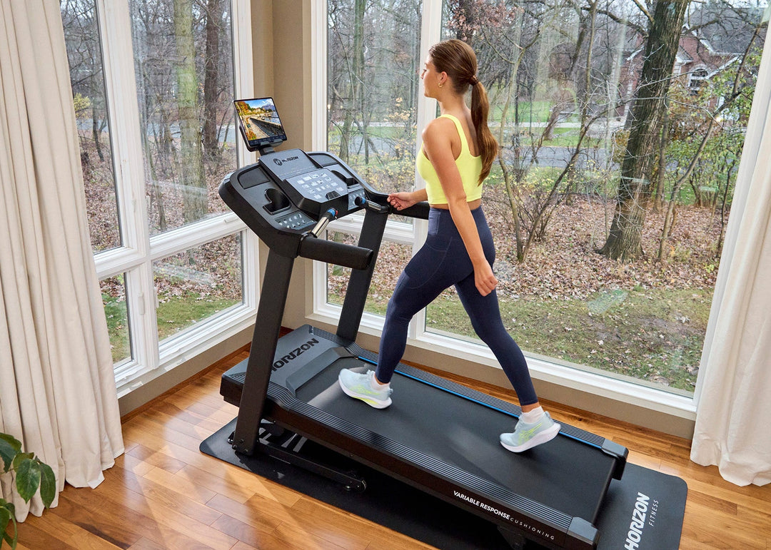 Person walking on the Horizon T101 Connect treadmill in a home workout space.