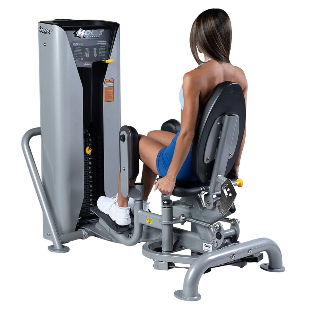 person using inner outer thigh machine performing hip adductor exercise